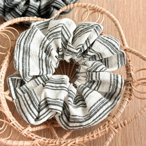 Macro view of blue striped scrunchie texture in a natural woven basket setting