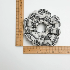 Blue and white striped scrunchie hair tie on measuring ruler showing 10cm diameter