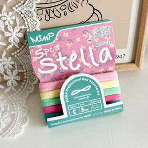 Detailed view of five colorful seamless elastic hair ties on elegant premium card packaging
