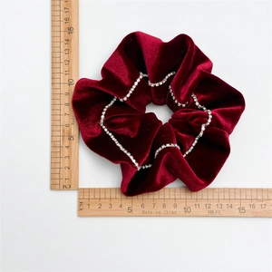 Elegant burgundy velvet scrunchie with rhinestone chain detail measuring 11cm diameter