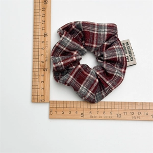 Vintage red plaid scrunchie with classic checkered pattern for academic style hair styling