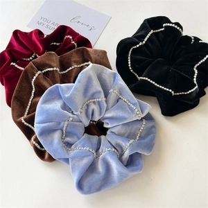 Elegant velvet scrunchies with rhinestone chain details in four assorted colors