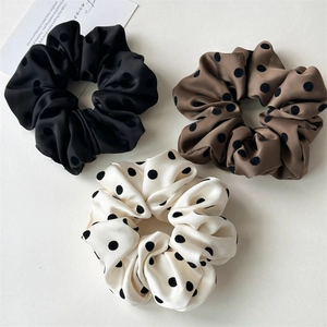 Three-piece set of satin polka dot scrunchies in black, brown, and cream white colors