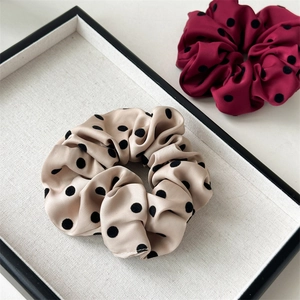 Satin polka dot scrunchies in champagne and burgundy colors with smooth silk texture
