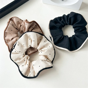 Three-piece set of vintage floral and polka dot fabric scrunchies for bun hairstyles