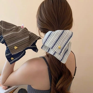 Detail of striped bow hair scarf with vintage patterns and gold heart-shaped love metal buckle