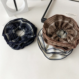 Three-piece set of retro striped fabric scrunchies in navy, brown, and beige tones
