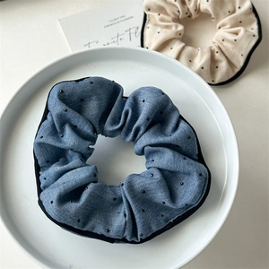 Retro fabric hair scrunchies set with blue and cream colors in a stylish macro shot