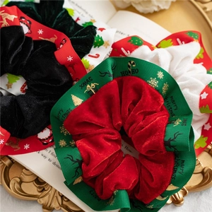 Christmas velvet hair scrunchies with festive elk and Santa patterns in a gold tray