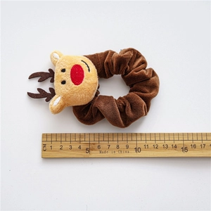 Brown plush Christmas reindeer hair scrunchie with measuring ruler for size reference