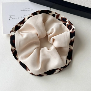 Close-up of a leopard print scrunchie with high elasticity and ruffled polyester fabric