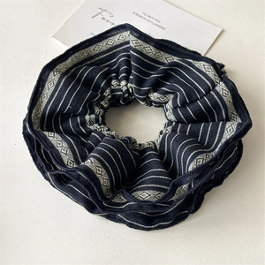 Macro detail of navy blue striped fabric scrunchie with jacquard woven texture