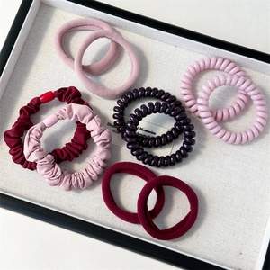 Detail view of 10-piece scrunchie and spiral telephone wire hair tie set in a gift tray