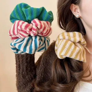 Detail of knitted striped hair scrunchies showing soft texture and cozy winter fabric