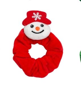 Detail of red velvet Christmas scrunchie with a cute snowman plush decoration and red hat
