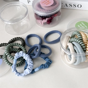 Detail of Morandi-toned hair accessories set including telephone wire bands and a storage jar