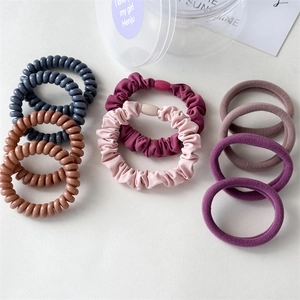 Detail of multi-style hair ties set including spiral cords and fabric scrunchies