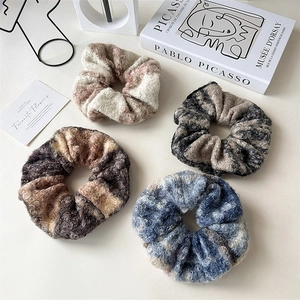 Set of four plush oversized woolen scrunchies in winter Morandi colors on art background