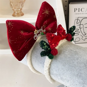 Close-up of velvet Christmas headband with gold stars and Merry Christmas metal charm
