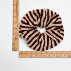 Brown and beige striped knitted scrunchie showing 16cm diameter on a white background