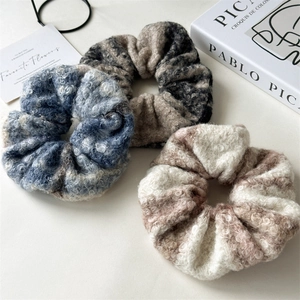 Close-up of three oversized plush wool scrunchies with soft texture for autumn and winter
