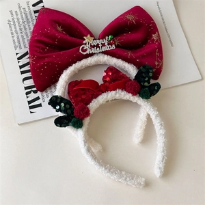 Detail of red velvet and white plush Christmas headbands with sequins and festive bows