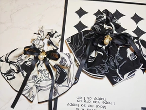 Detail of chiffon floral scrunchies with bow ribbon, faux pearls and heart charms
