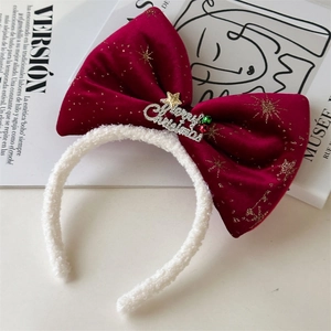 Detail of red velvet Christmas bow headband with golden Merry Christmas metallic lettering