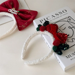 Detail of Christmas headbands with red velvet bows, sequins and white faux fur texture