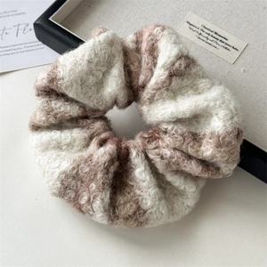 Detail of plush wool blend beige and brown checkered oversized hair scrunchie