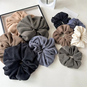 Large plush velvet scrunchies set in neutral colors for autumn and winter hairstyles