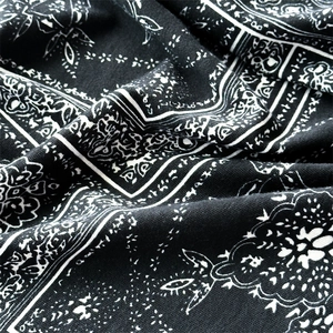 Macro detail of high-quality black and white paisley cotton fabric for headband