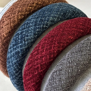 Macro shot of colorful thick sponge headbands with textured tweed fabric weave detail