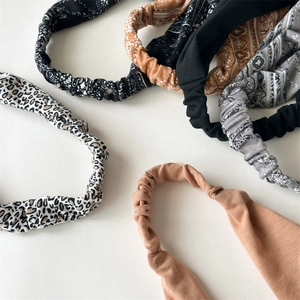 Close-up of elastic paisley and leopard print headwraps with boho fabric textures
