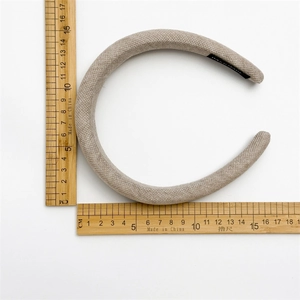 Detail showing the thick textured fabric headband with handmade tag and 15cm measurement