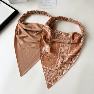 Detail of bohemian paisley headbands with elastic strap in brown and printed patterns