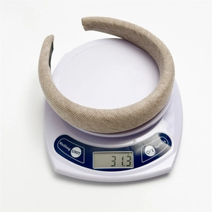 Weight display of wide beige fabric headband showing 31.3g on a white digital scale