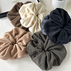 Detail shot of plush velvet scrunchies in five autumn colors with soft fuzzy texture