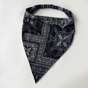 Detail of bohemian paisley print elastic headband headscarf in black and white pattern