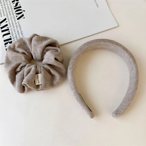 Detailed texture of oat knit headband and scrunchie set with handmade fabric label