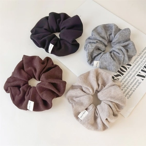 Set of 4 ribbed knit scrunchies in black, gray, brown, and beige with handmade labels