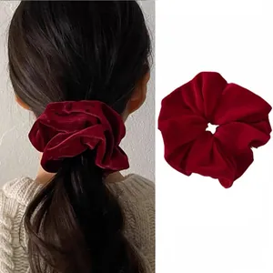 Detailed close-up and model view of a vintage dark red velvet scrunchie for hair styling