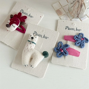 Handmade crochet hair clips set featuring cute reindeer, alpaca, and blue flower designs