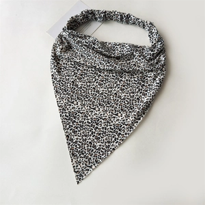 Detailed view of leopard print triangle headscarf with elastic band on white background