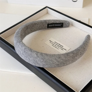 Detailed macro view of the soft knitted texture and handmade label on the grey headband