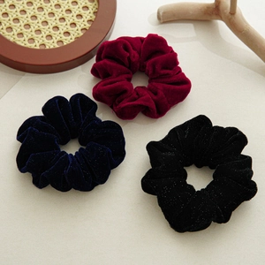 Three-piece set of velvet scrunchies in wine red, navy blue, and black with subtle glitter