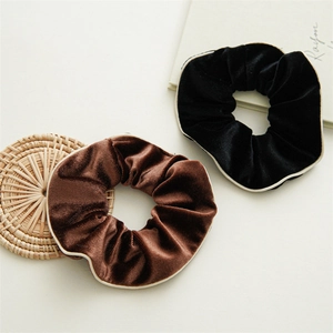 Minimalist vintage velvet hair scrunchies in black and brown with elegant cream borders