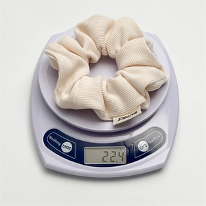 Chic cream ribbed plush scrunchie with high elasticity and brand label weighing 22.4g