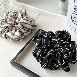 Elegant satin striped oversized scrunchies in beige and black for stylish hair styling