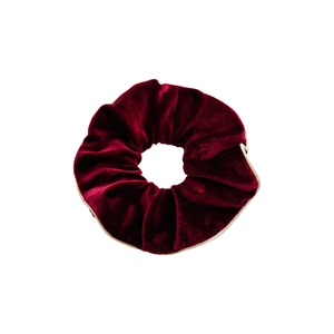Elegant wine red velvet scrunchie with golden piping trim on a clean white background